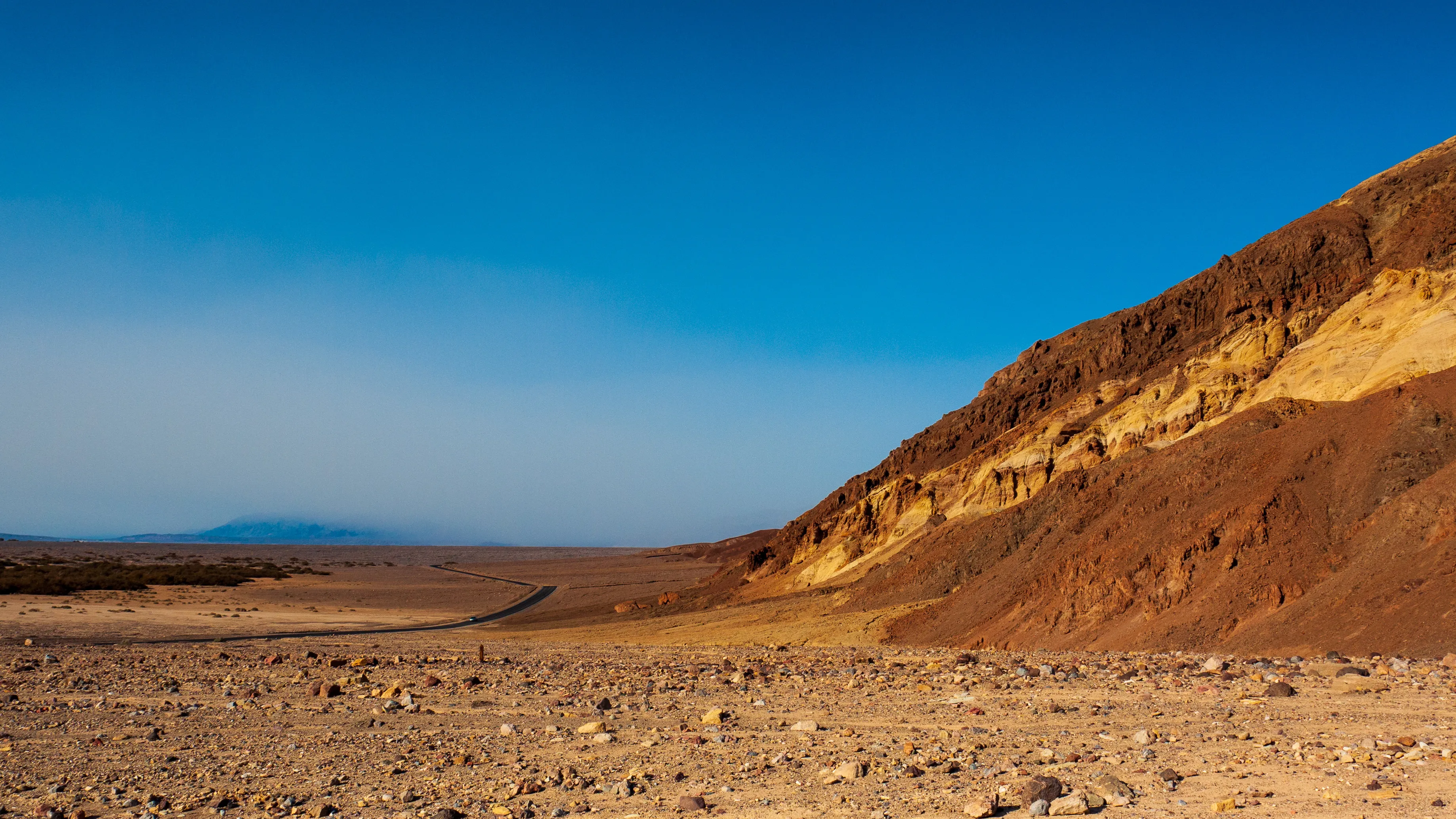 Desert landscape with rocky hills under clear blue sky