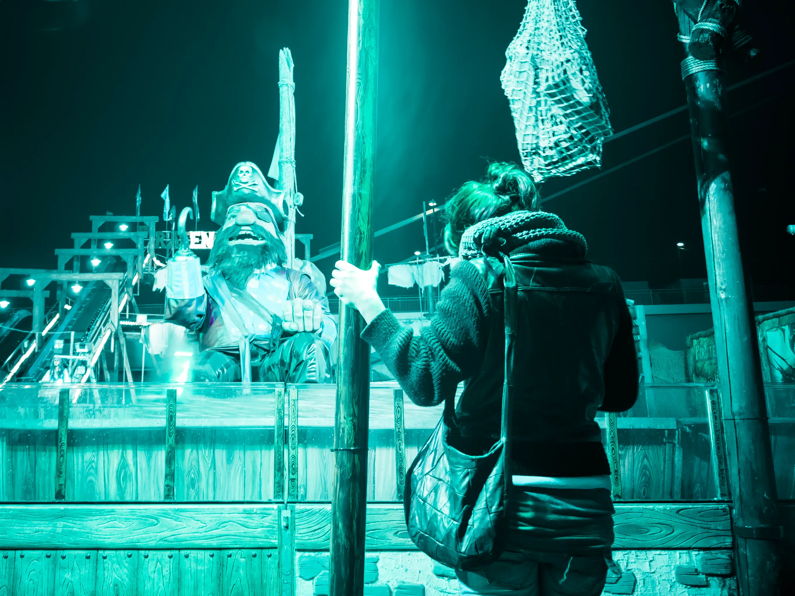 Person examining an ice sculpture at night.
