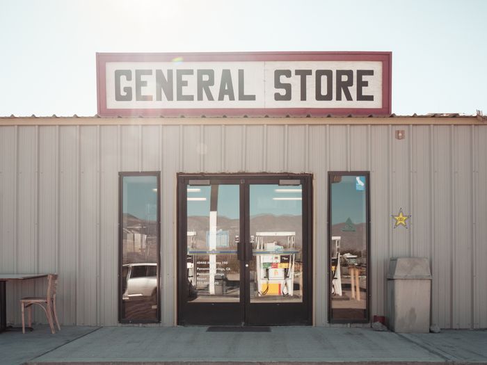 General Store with large windows, sign on roof, and a star decal on the wall