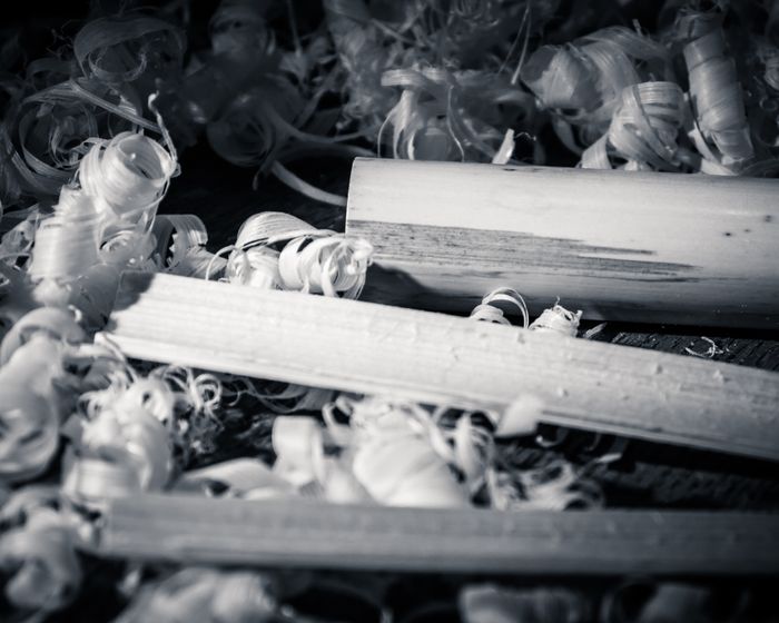 Close-up of scattered, tangled keys in black and white.