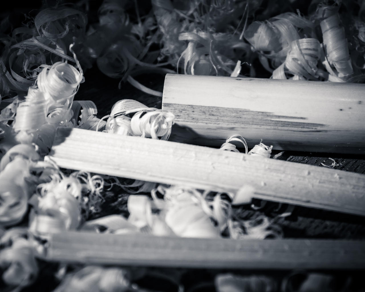 Close-up of scattered, tangled keys in black and white.