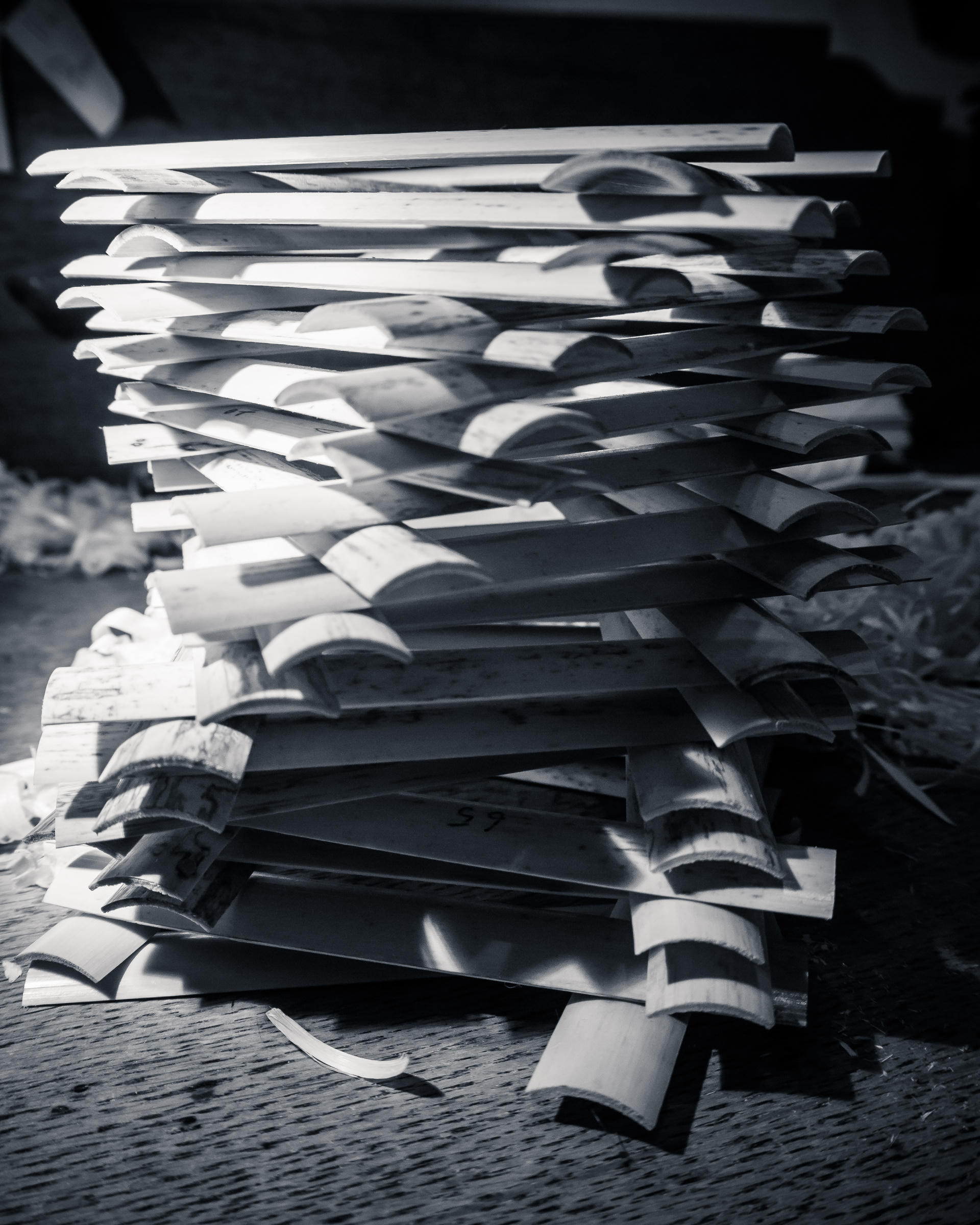 Stacked, open books with visible pages, creating a wave-like pattern. Black and white photograph.