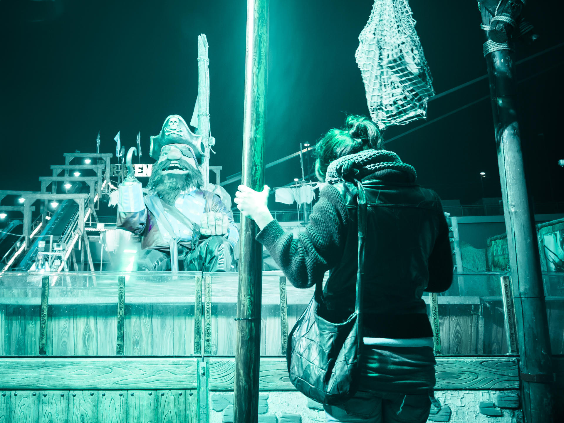 Person examining an ice sculpture at night.